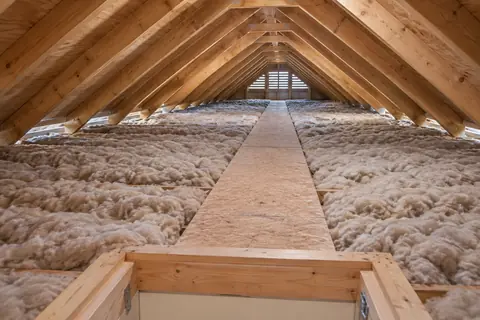 Attic with timber framing, insulation and a raised access walkway